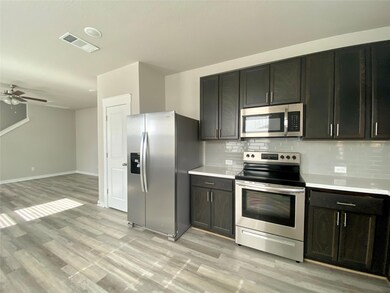 Kitchen with stainless steel appliances, backspla