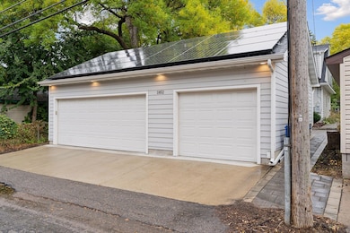 Extraordinary three-car garage—two separate, fully finished, climate-controlled bays—plus a fully paid-off solar array that provides ongoing energy credits and long-term savings.