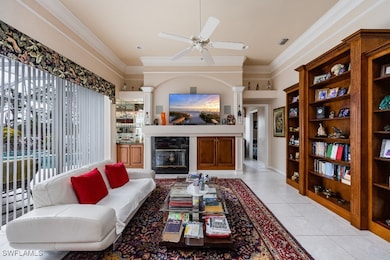 Living room featuring ceiling fan, light tile patt