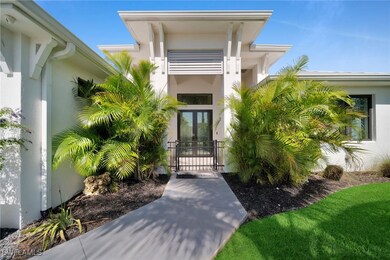 View of exterior entry with french doors, a gate,