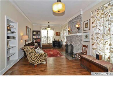 The living room is large and has lovely hardwood f