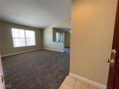 Unfurnished room featuring baseboards, light carpe