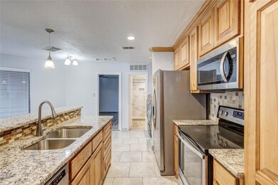 Kitchen with a sink, visible vents, light stone co