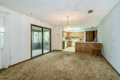 Dining area wtih patio door to lanai