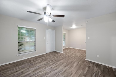Spare room featuring dark hardwood / wood-style flooring and ceiling fan