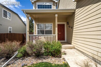 View of exterior entry featuring a porch and fence