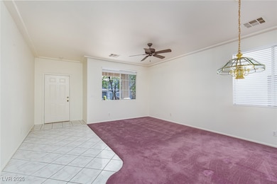 Unfurnished room with light carpet, a ceiling fan,