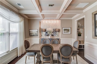 Dining area with wainscoting, a healthy amount of 