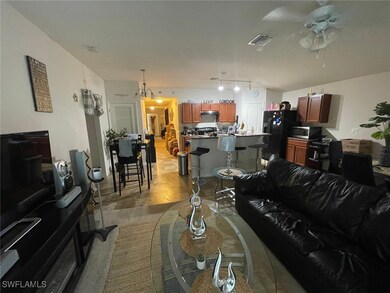 Living room with ceiling fan and rail lighting