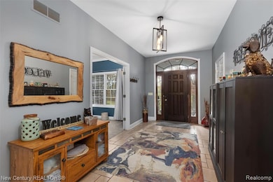 Foyer entrance featuring baseboards and light tile patterned floors