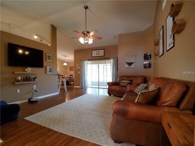 Open Living Room with High Ceiling and Fan.
