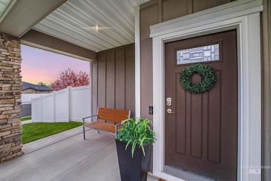 Property entrance featuring board and batten siding and a patio area