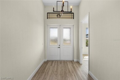 Entryway featuring a notable chandelier and light