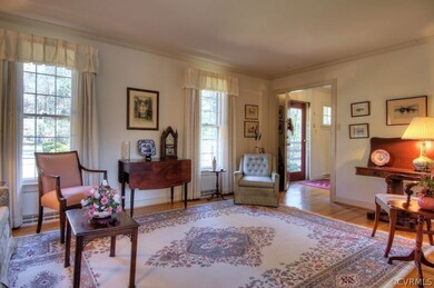 Formal family room with hardwood floors and crown