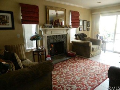 Sitting room overlooking brick patio and gas firep