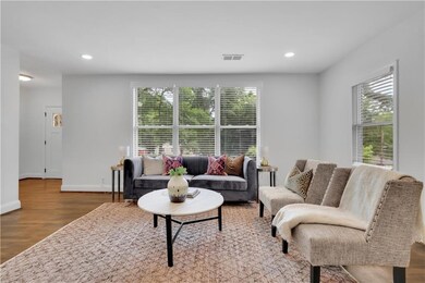 Living room with healthy amount of natural light, wood finished floors, recessed lighting, and baseboards