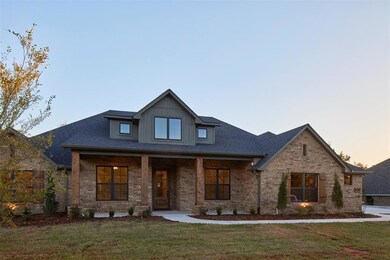 View of front of property featuring a lawn and cov