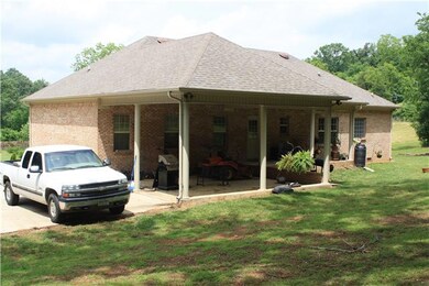 Back View of Home - With 2-car carport and another covered porch.