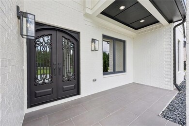Property entrance with french doors and brick siding