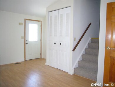 Living Room Stairway to bedrooms closet and front 
