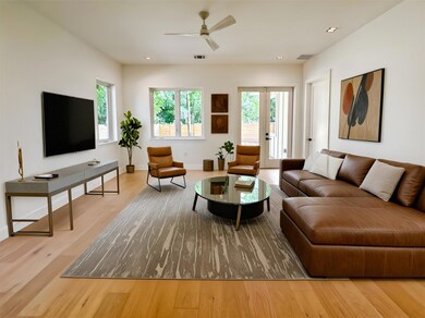 Living room featuring ceiling fan, wood finished 