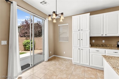 Unfurnished dining area with a chandelier and ligh