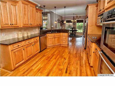 Granite countertops, tile backsplash, and beautiful custom cabinets complete this fantastic kitchen.