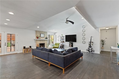 Living area featuring dark wood-type flooring, a f