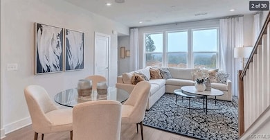 Living area with stairway, wood finished floors, b