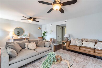 Living area with wood finished floors, visible ve
