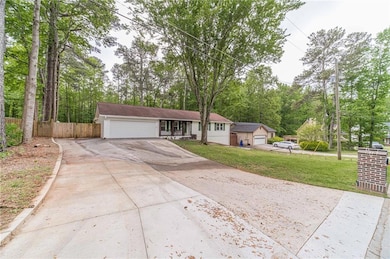 Ranch-style house with fence, a front lawn, a gara