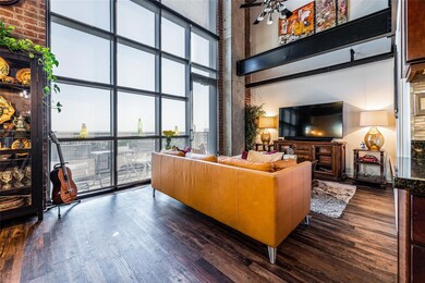 Living room with high ceiling and open floor.