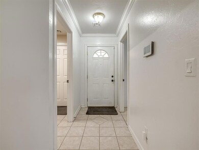 Entryway with light tile patterned floors and orna
