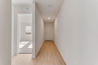 Corridor featuring light hardwood / wood-style flo