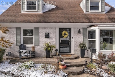 View of exterior entry featuring brick siding and roof with shingles