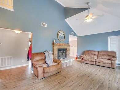 Living roomflooring, fireplace, and staircase.