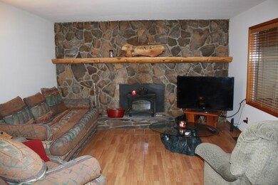 Living Room with Rock and wood Mantel