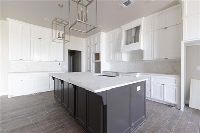 Kitchen featuring dark wood-style floors, a kitchen island, white cabinetry, and decorative backsplash