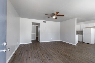 Unfurnished living room featuring dark wood-type 