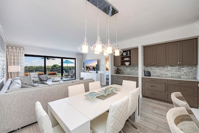 Dining area featuring ornamental molding and wood finish floors