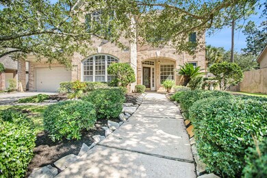 A winding, flagstone pathway adorned with lush landscaping leads up to the covered front porch!