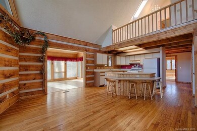 View From Great Room to Kitchen, Sunroom and Loft Upstairs
