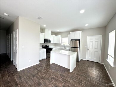 Kitchen featuring stainless steel appliances, a sink, baseboards, white cabinets, and light countertops