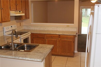 Kitchen view from breakfast nook cut-out to family