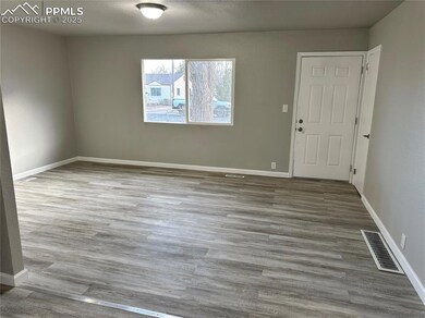 Unfurnished room featuring baseboards, visible ven
