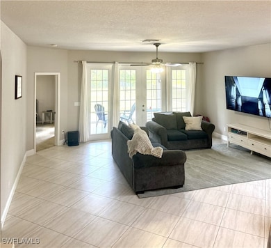 Living room, ceiling fan, french doors, and plenty