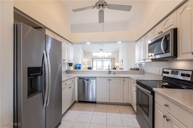 Kitchen with ceiling fan with notable chandelier,