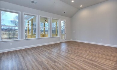 Spare room with lofted ceiling, baseboards, recess