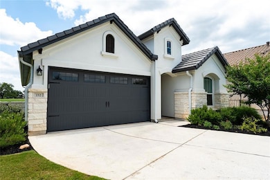 View of front of home with stone siding, an attac