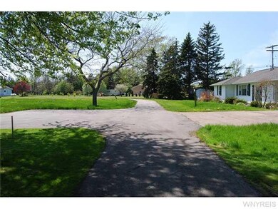 Exterior Front. . The shared private road curves a